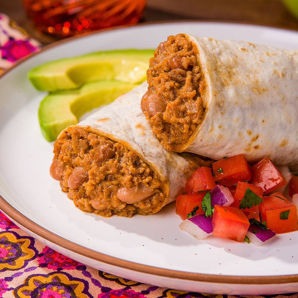 Beef & Bean Burritos on a plate with fresh salsa and avocado.